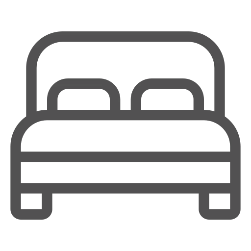 Cama con dos almohadas y cabecero.
