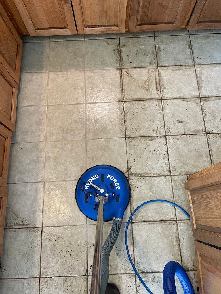 a person is cleaning a chair with a vacuum cleaner .