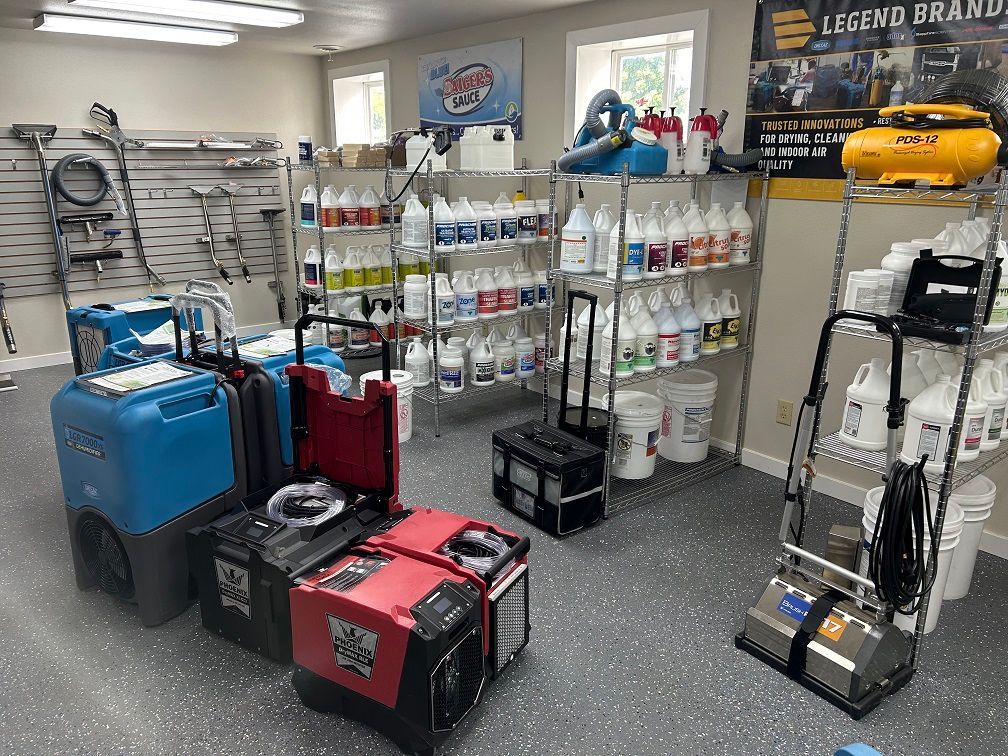 Inside a shop, carpet cleaning equipment and supplies are for sale.