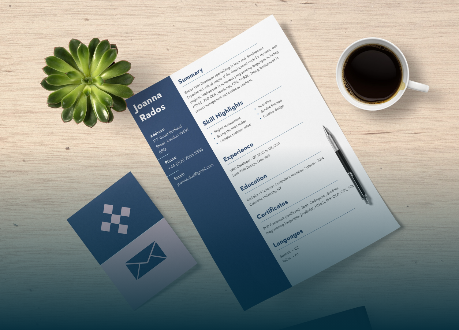 Resume with blue sidebar, pen, coffee, succulent, and business card on wood.