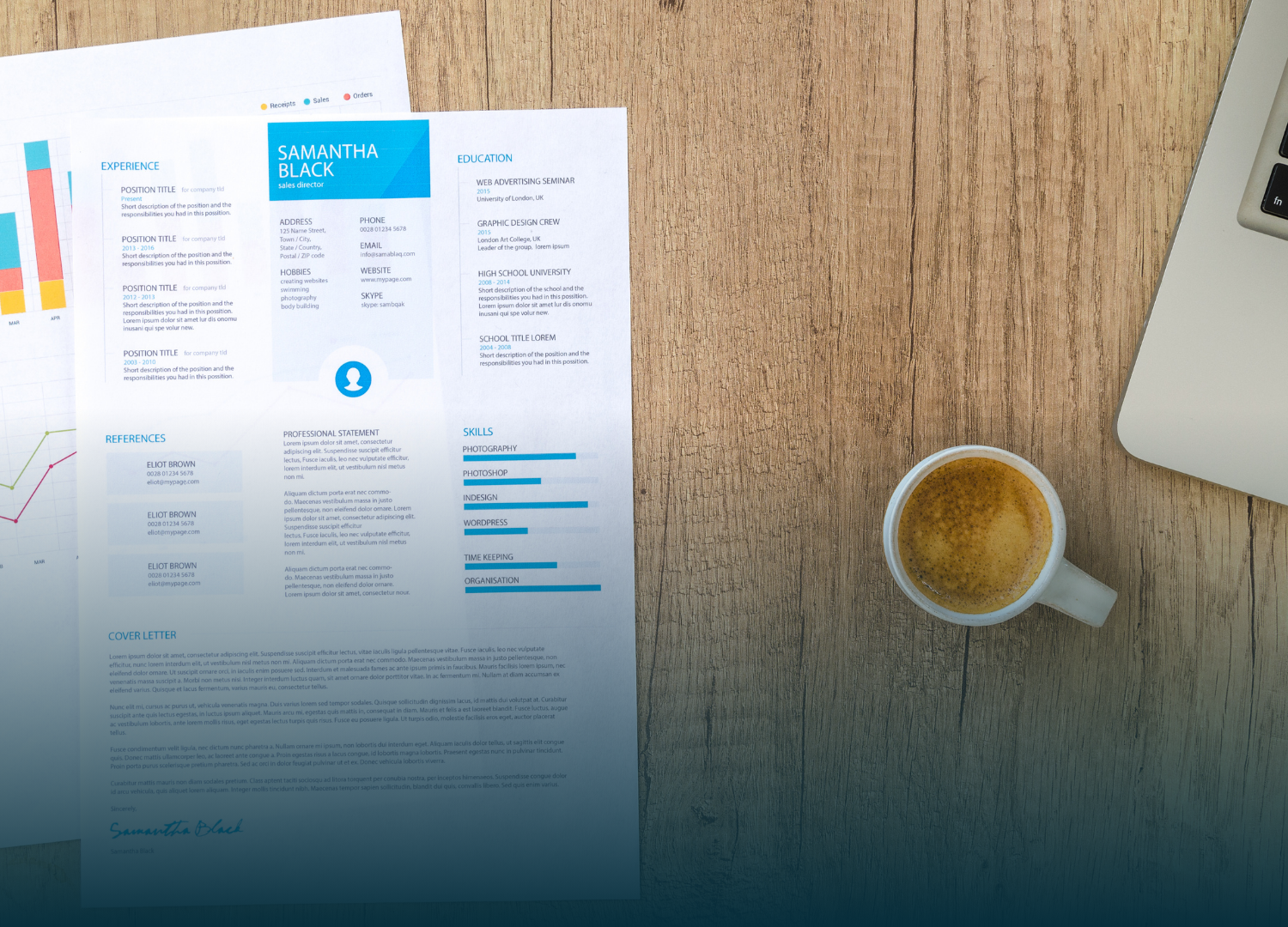 Resume and financial graphs on wooden desk with coffee and laptop.