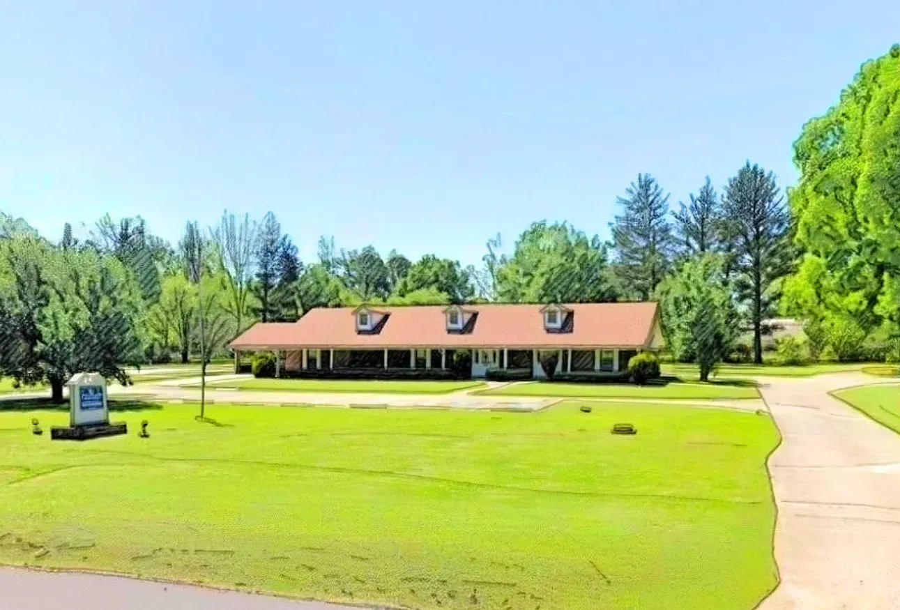 A large office building with a lot of windows on a sunny day.