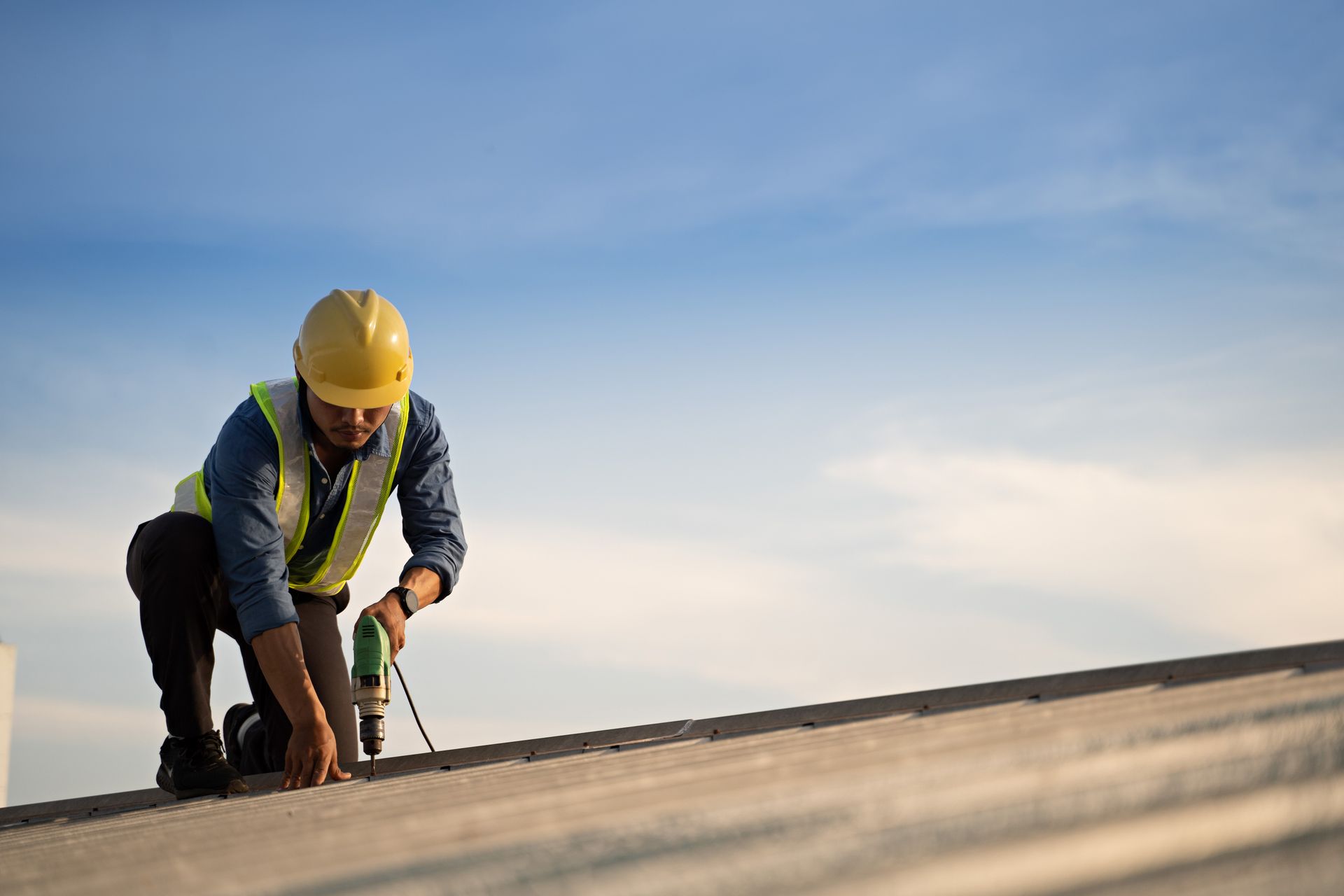 Worker repairing the roof on a construction site.