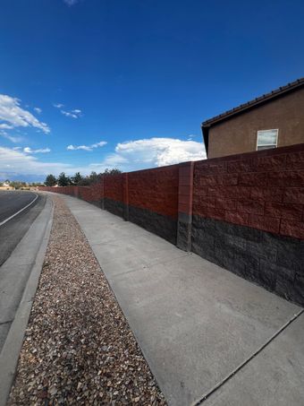 A tan brick wall with a logo