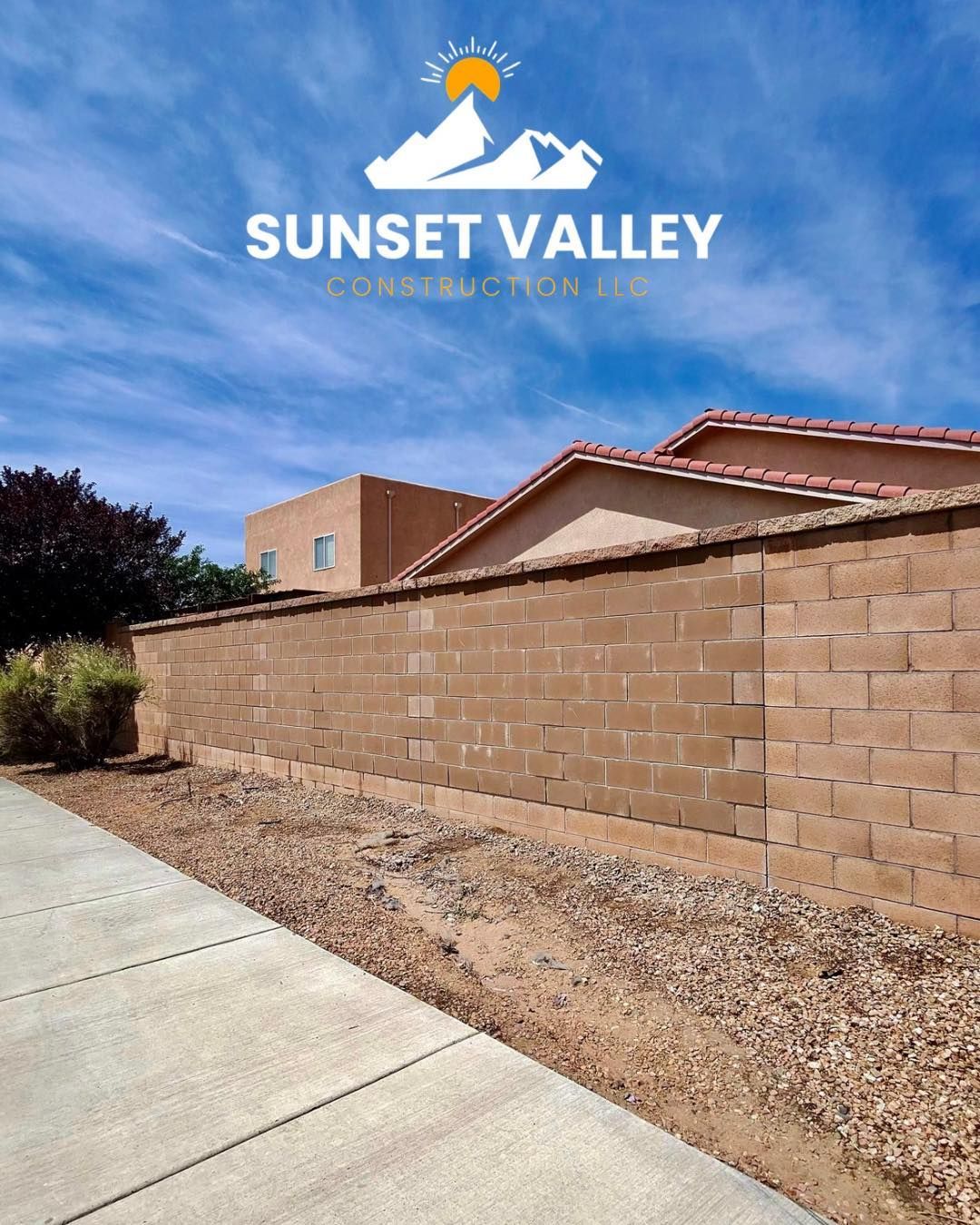Sunset Valley Construction logo over a tan block wall and building under a blue sky.