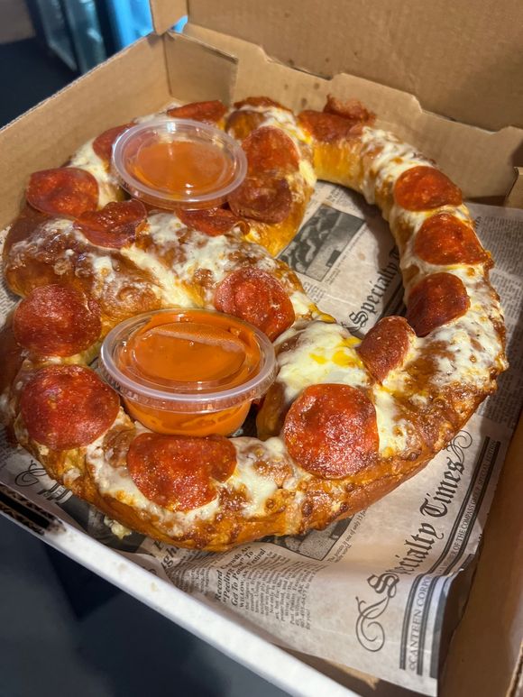 Pepperoni pizza pretzel with marinara dipping sauce in a To Go Box at On The Bay Restaurant