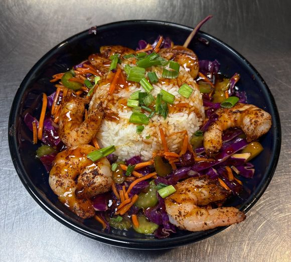 Shrimp bowl with rice, slaw, green onions, carrots at On The Bay restaurant