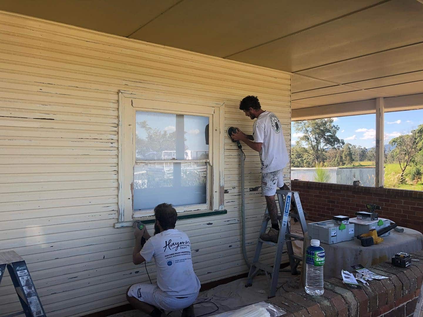 Two Men Are Painting the Side of a House — The Big Bearded Painter In Stroud, NSW