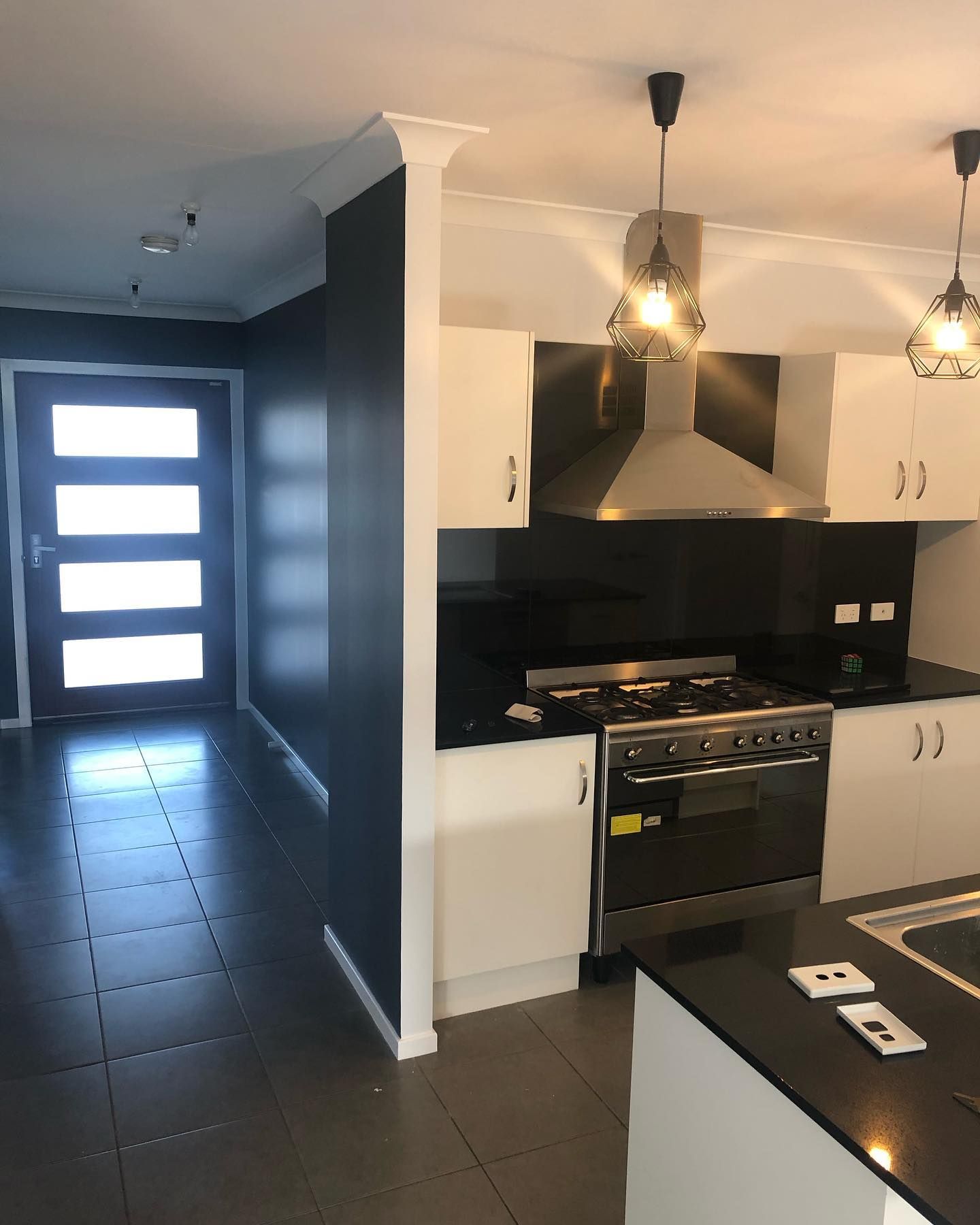 A Kitchen With Stainless Steel Appliances and White Cabinets — The Big Bearded Painter In Raymond Terrace, NSW