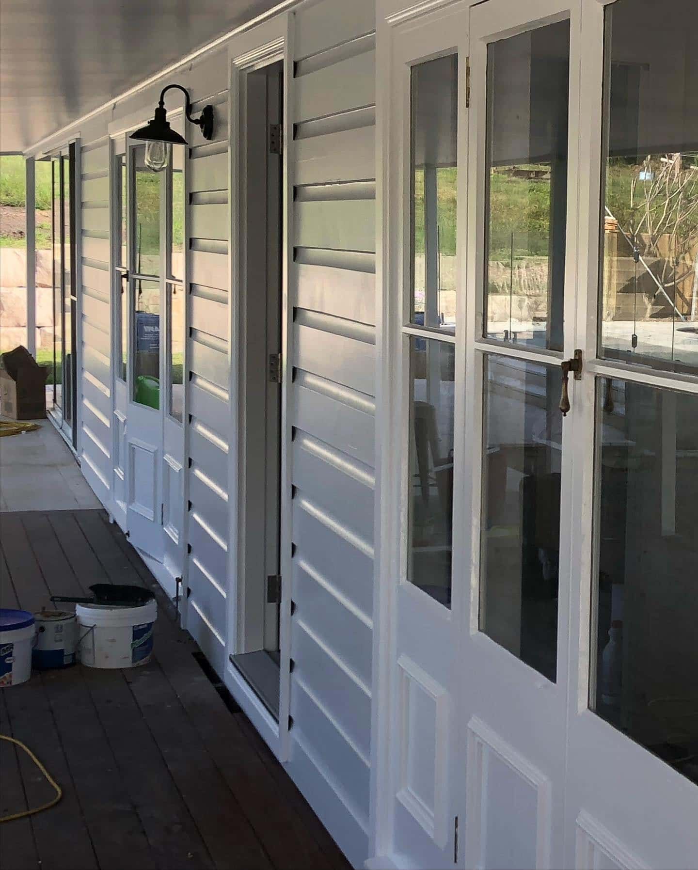A Long Hallway With White Doors and Glass Windows — The Big Bearded Painter In Maitland, NSW