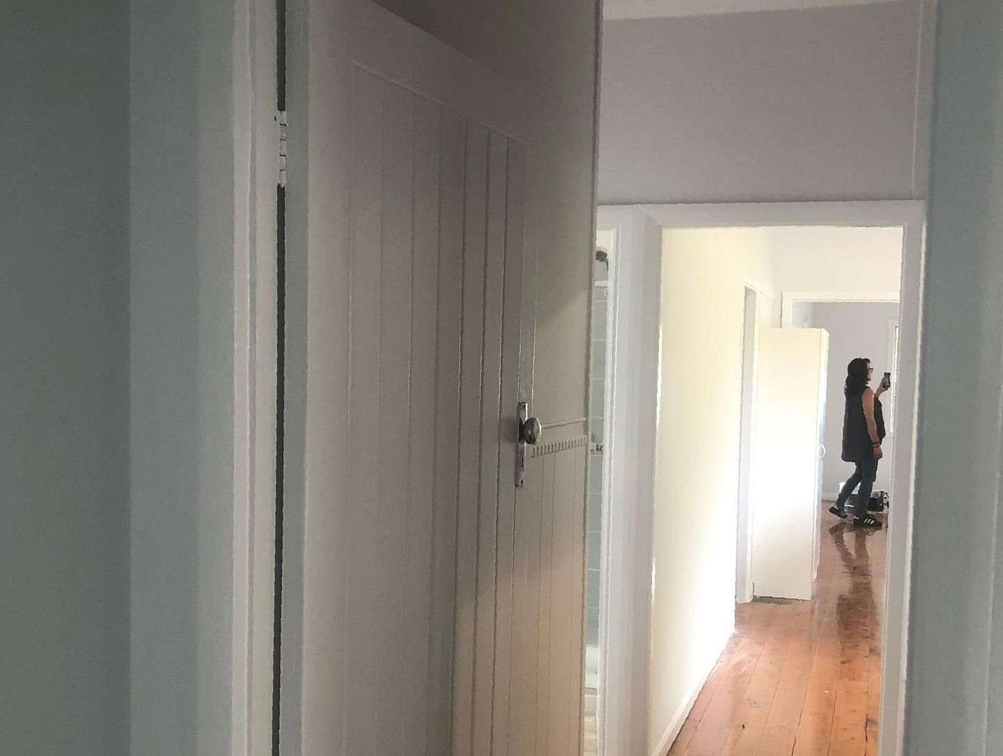 A Woman is Standing in a Hallway Next to a Door — The Big Bearded Painter In Newcastle, NSW