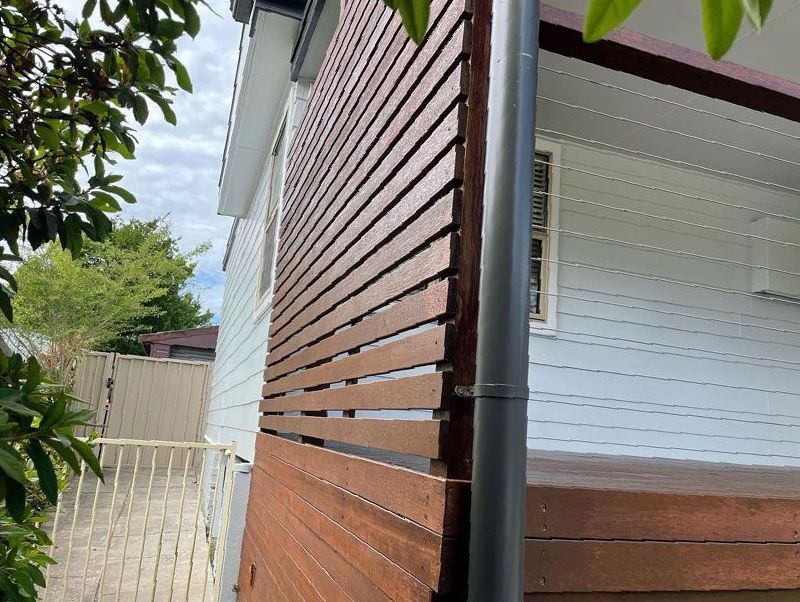 A White House With a Wooden Fence on the Side of It — The Big Bearded Painter In Hamilton, NSW