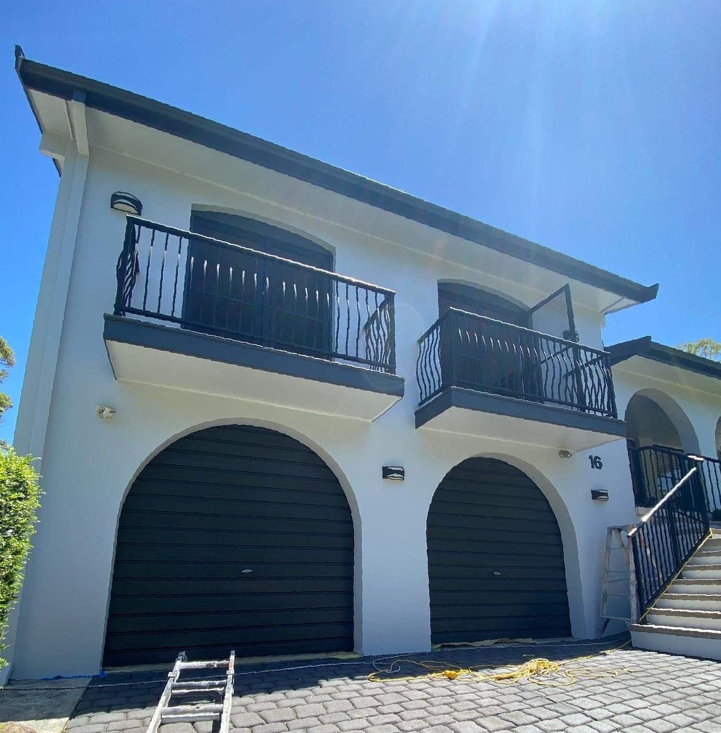 A White House With Black Garage Doors and Balconies — The Big Bearded Painter In Newcastle, NSW