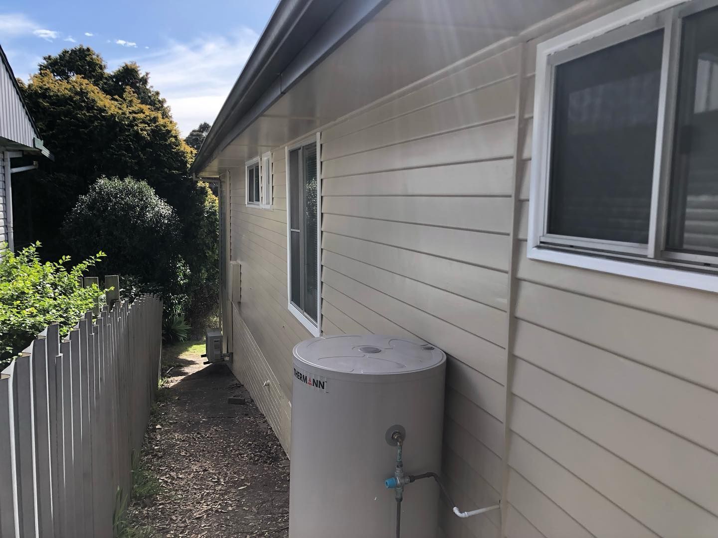 A House With a Water Heater on the Side of It — The Big Bearded Painter In Lake Macquarie, NSW