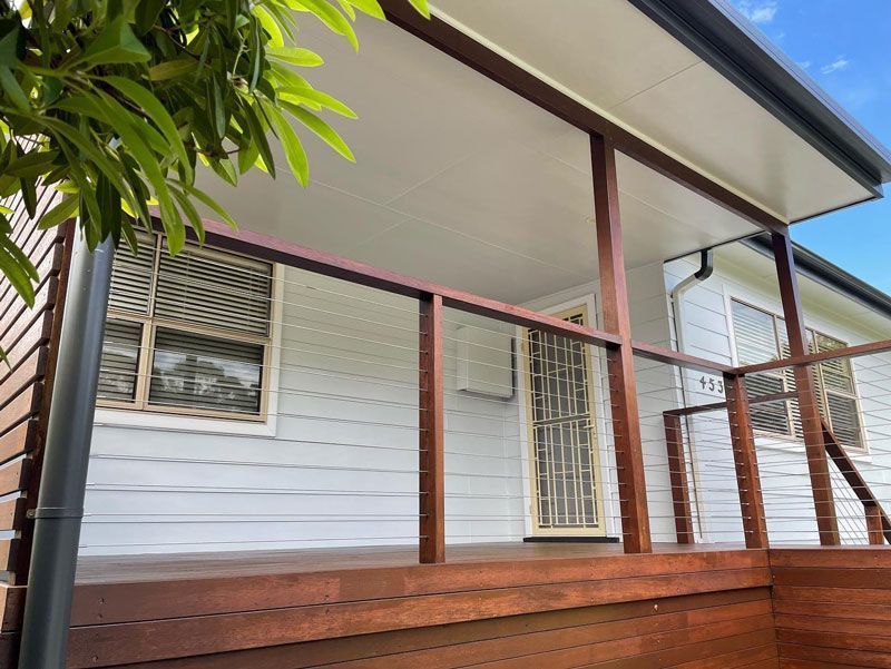 A White House With a Wooden Deck and a Wire Railing — The Big Bearded Painter In Booral, NSW