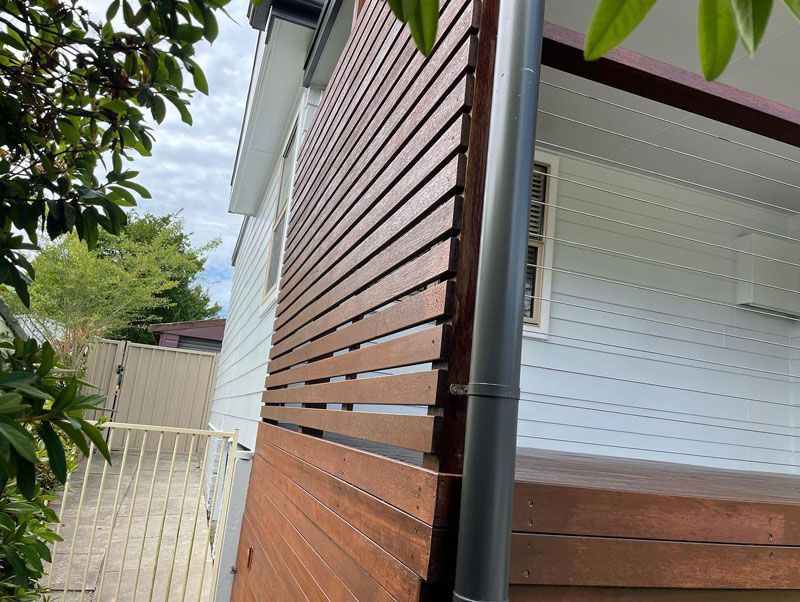 A White House With a Wooden Fence on the Side of It — The Big Bearded Painter In Raymond Terrace, NSW