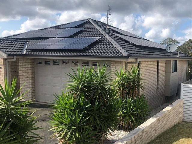 A House With Solar Panels on the Roof and a Garage Door — The Big Bearded Painter In Lake Macquarie, NSW