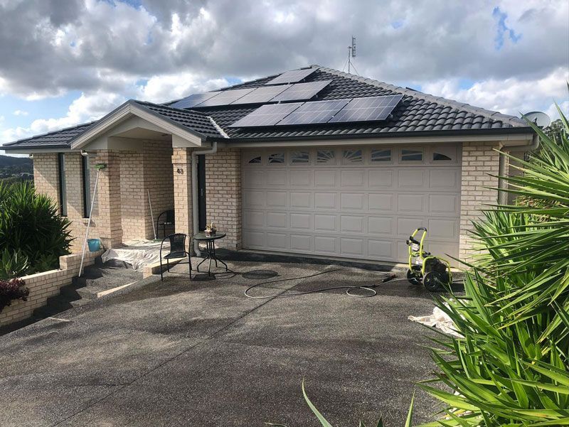 A House With a Garage Door and Solar Panels on the Roof  — The Big Bearded Painter In Lake Macquarie, NSW