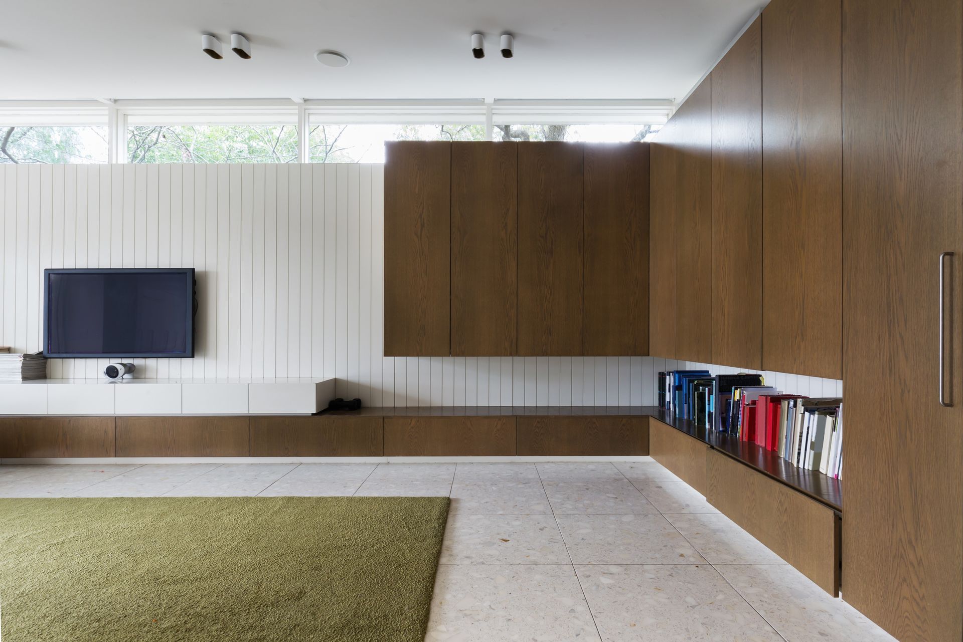 A living room with a flat screen tv on the wall