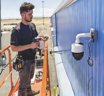 Boss Security Systems installing a security camera on a commercial building in Stockton CA