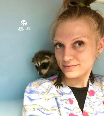 Jenna with baby raccoon
