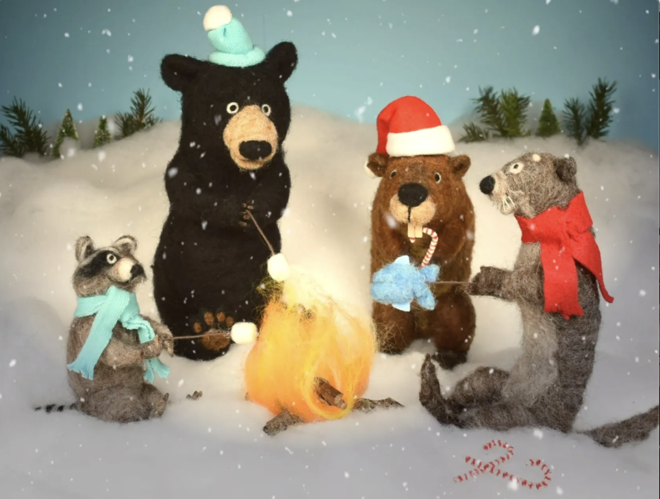 A group of stuffed animals wearing santa hats and scarves