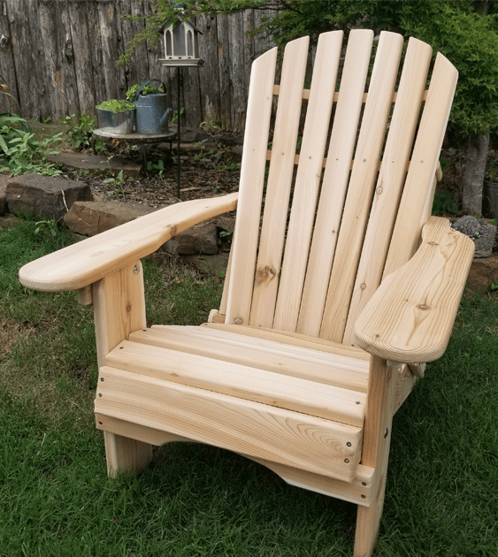 A wooden chair is sitting in the grass in front of a wooden fence