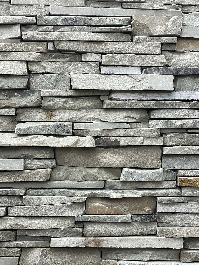 A close up of a stacked stone wall.