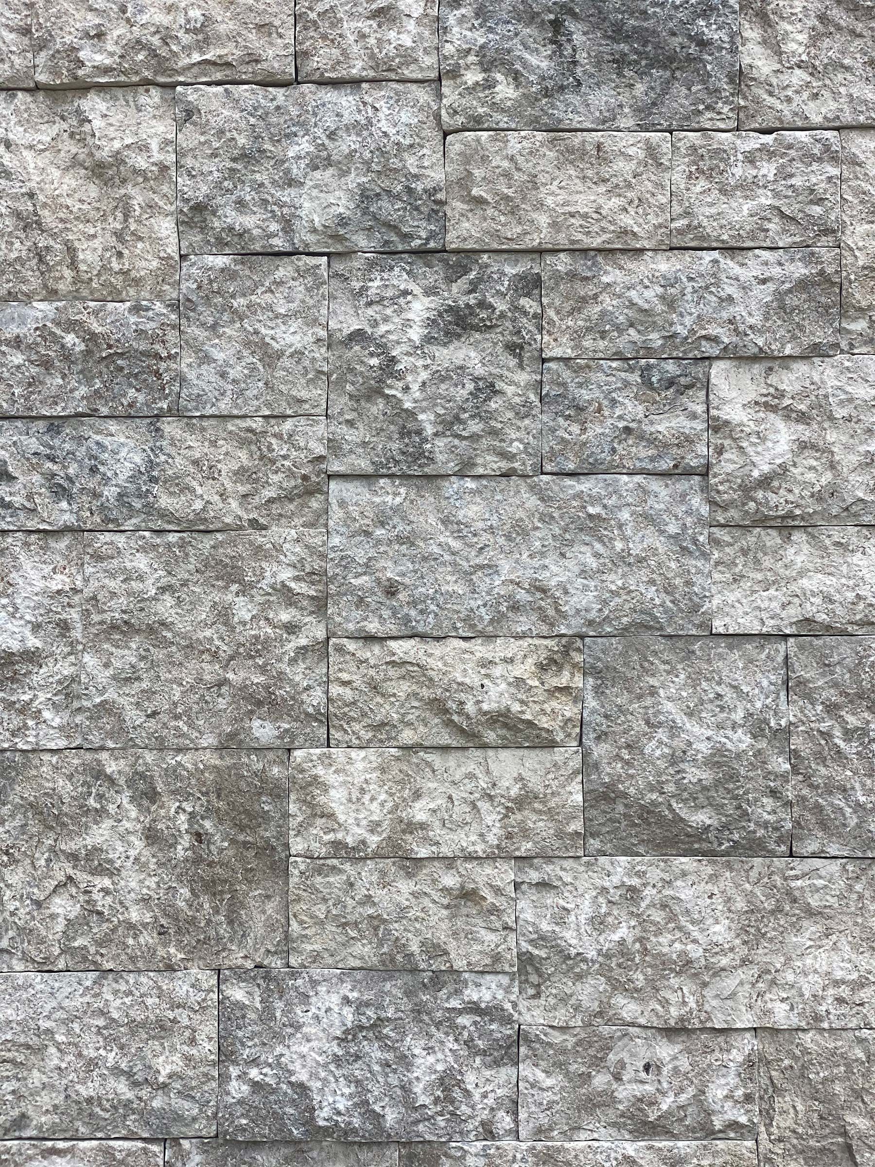 A close up of a brick wall made of granite.