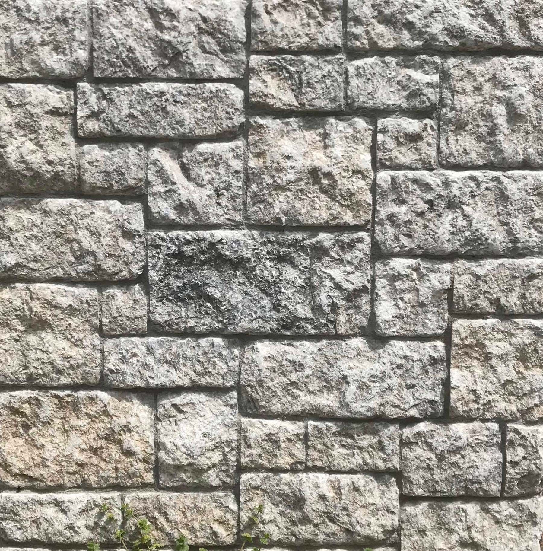 A close up of a stone wall with a lot of bricks.
