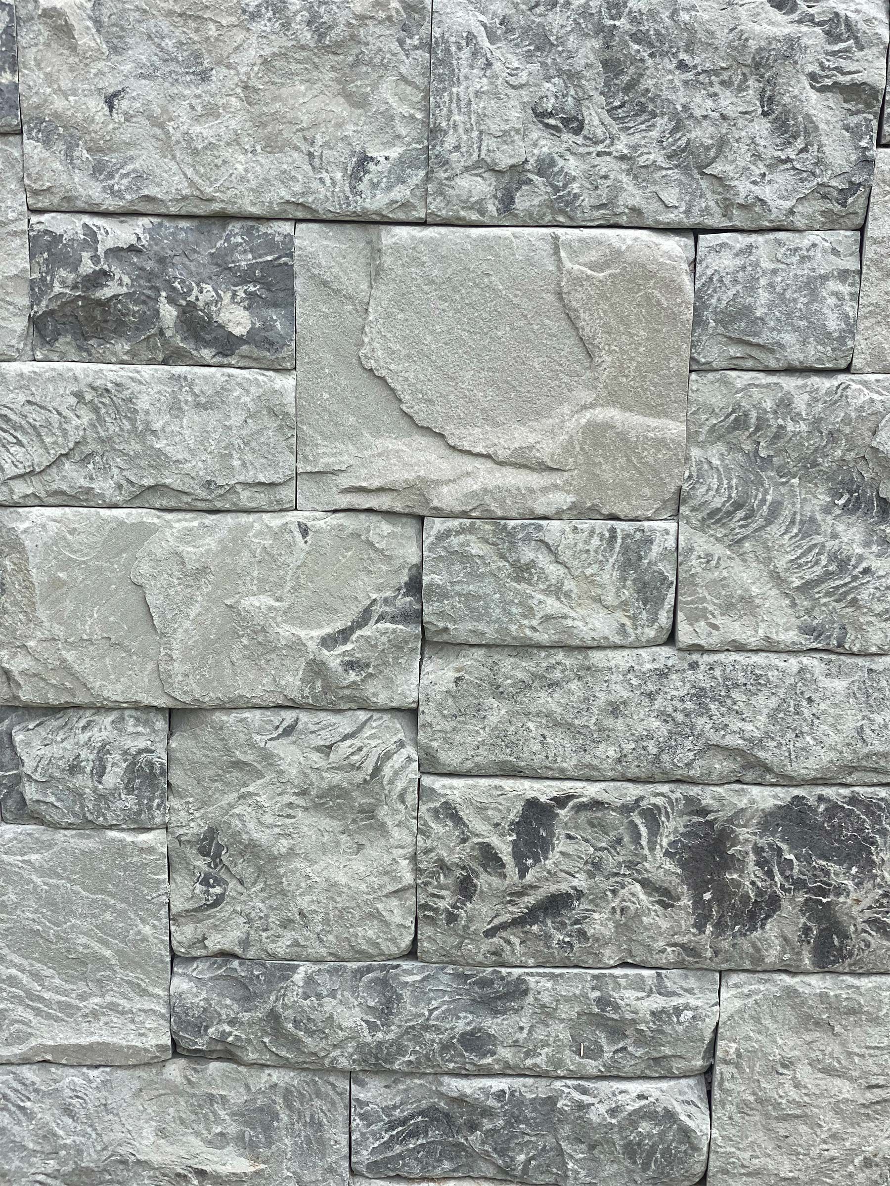A close up of a brick wall with a lot of bricks on it.