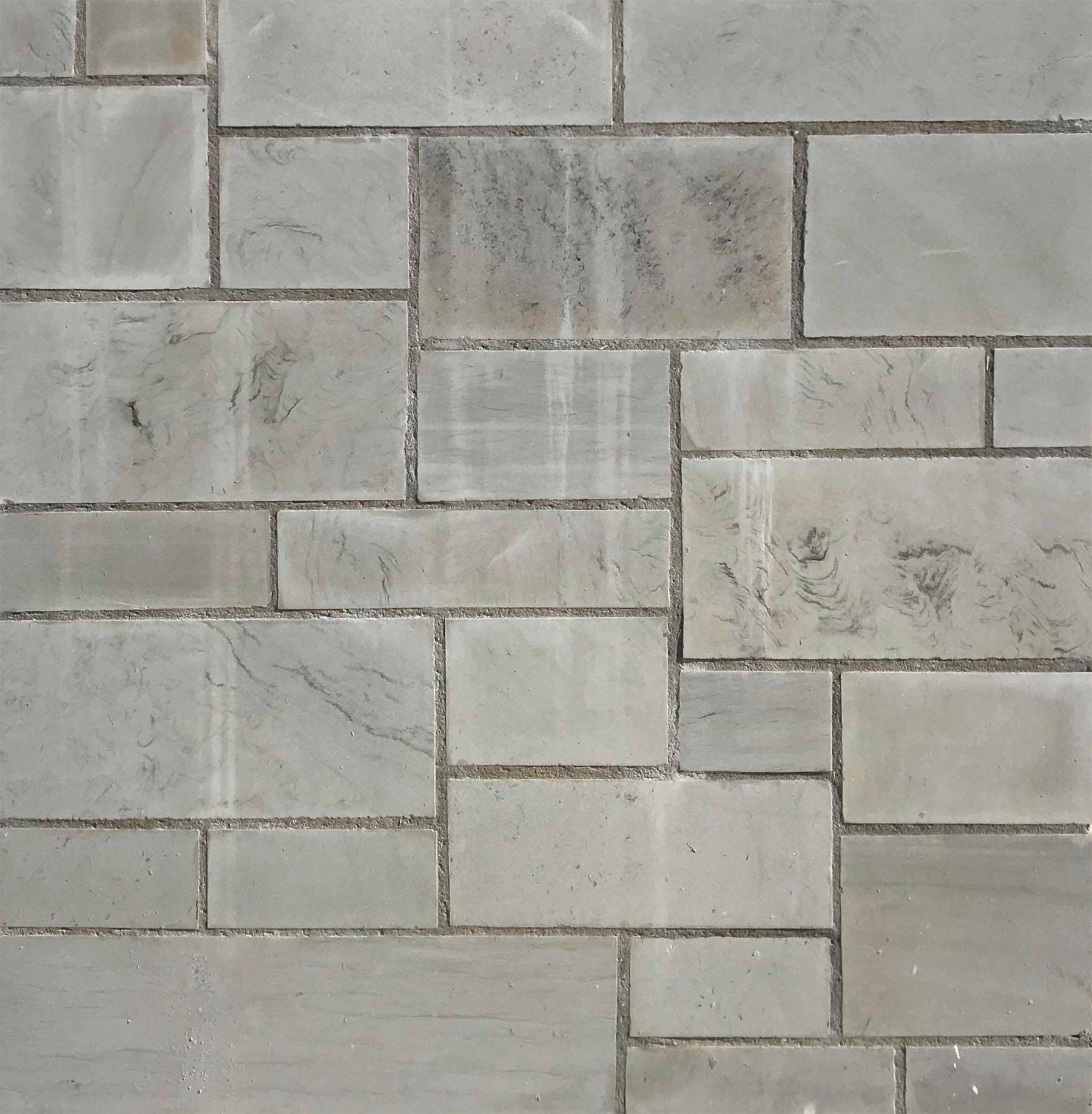 A close up of a brick wall with a pattern