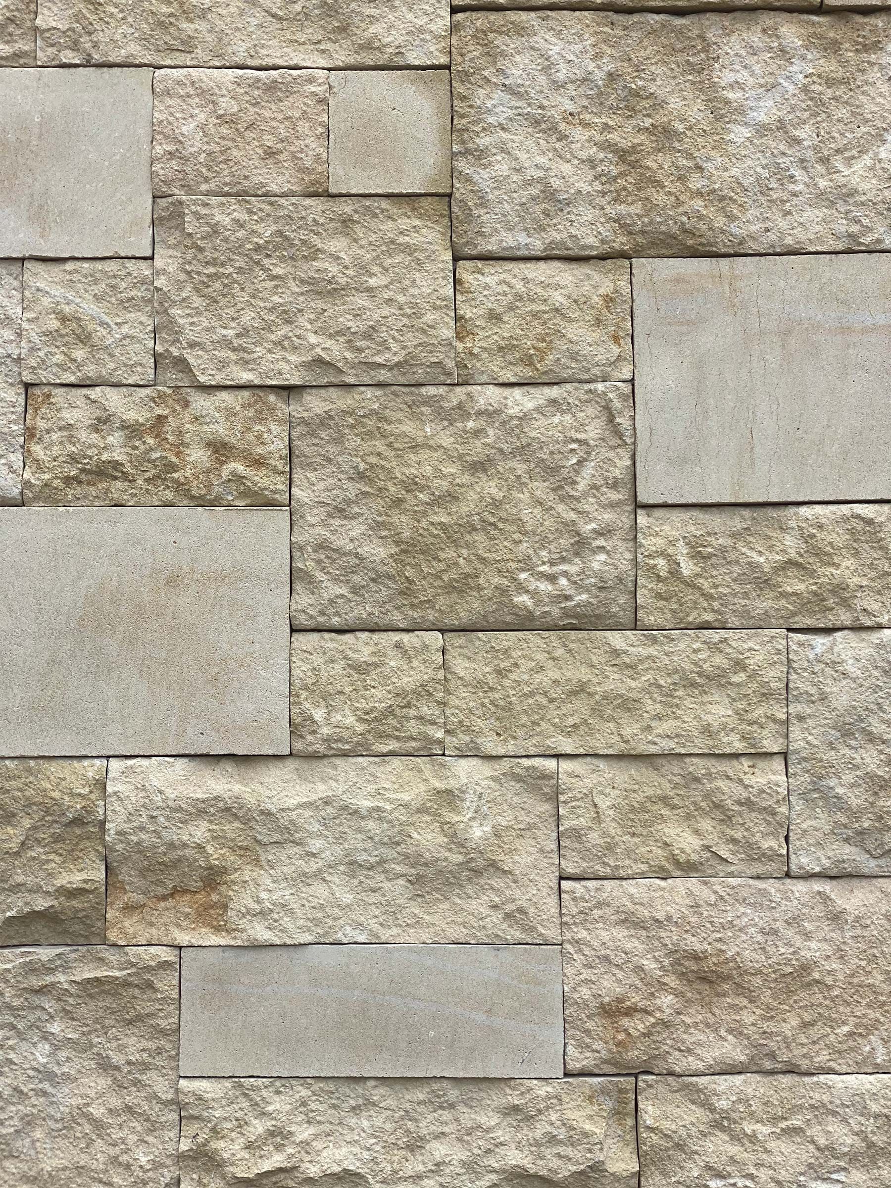 A close up of a stone wall with a lot of bricks on it.