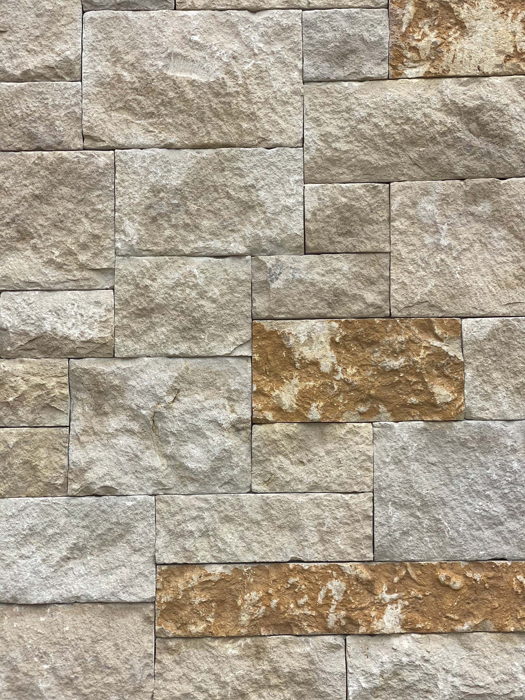 A close up of a brick wall with a brown stripe.