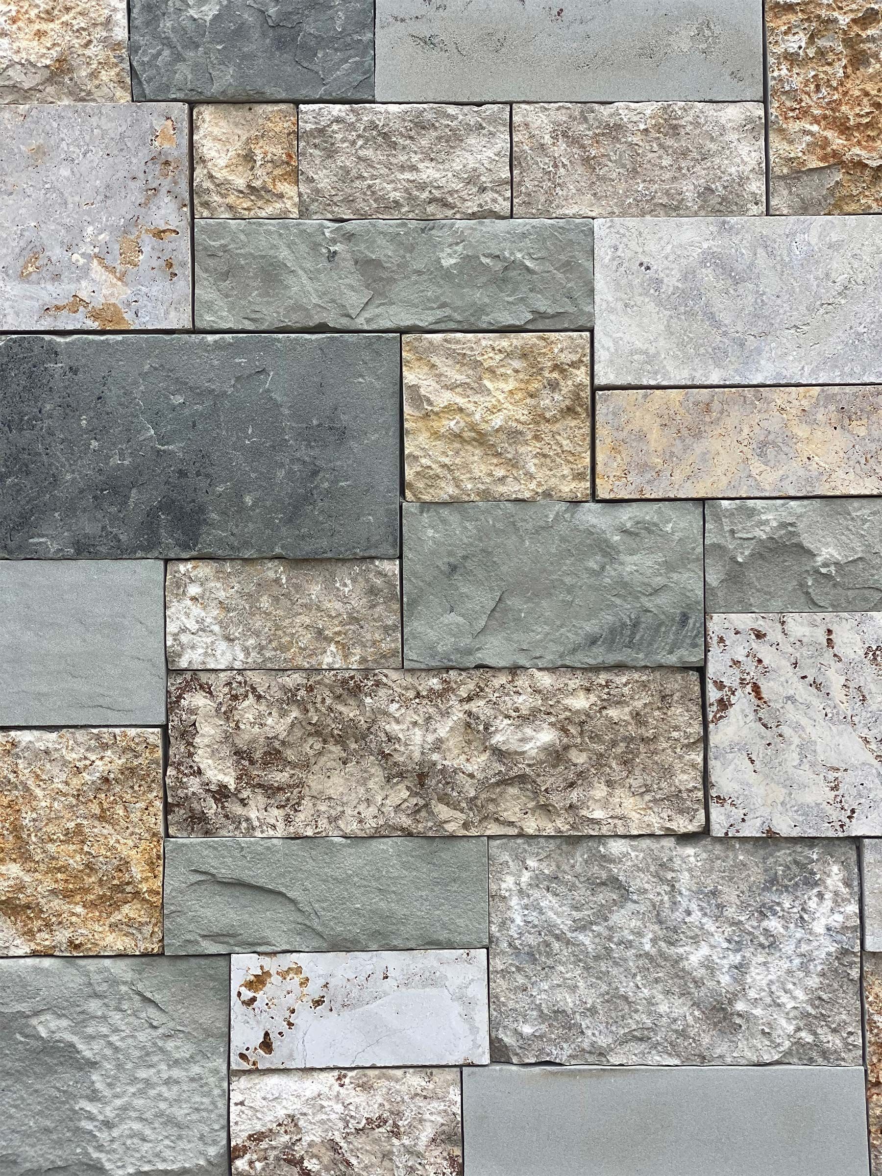 A close up of a brick wall made of different colored bricks