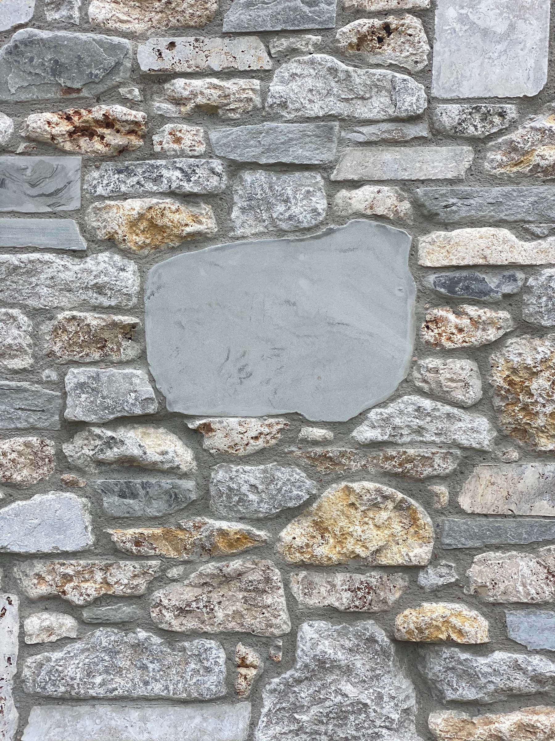 A stone wall with a hole in the middle of it.