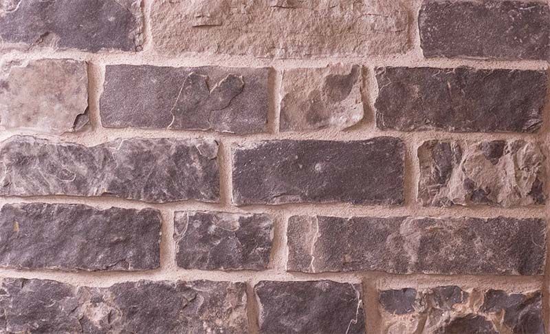 A close up of a brick wall with a lot of bricks
