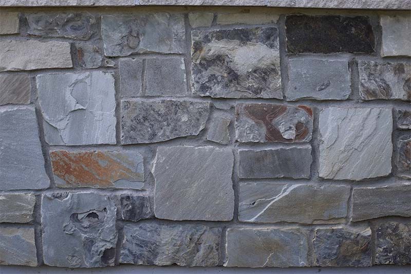 A close up of a stone wall with a lot of bricks