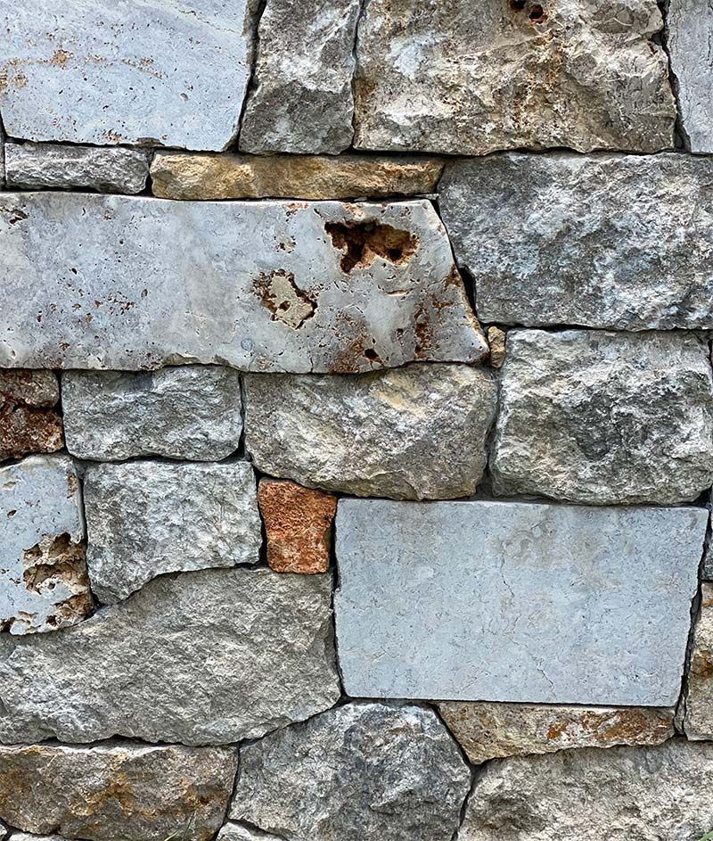 A close up of a stone wall with a lot of bricks