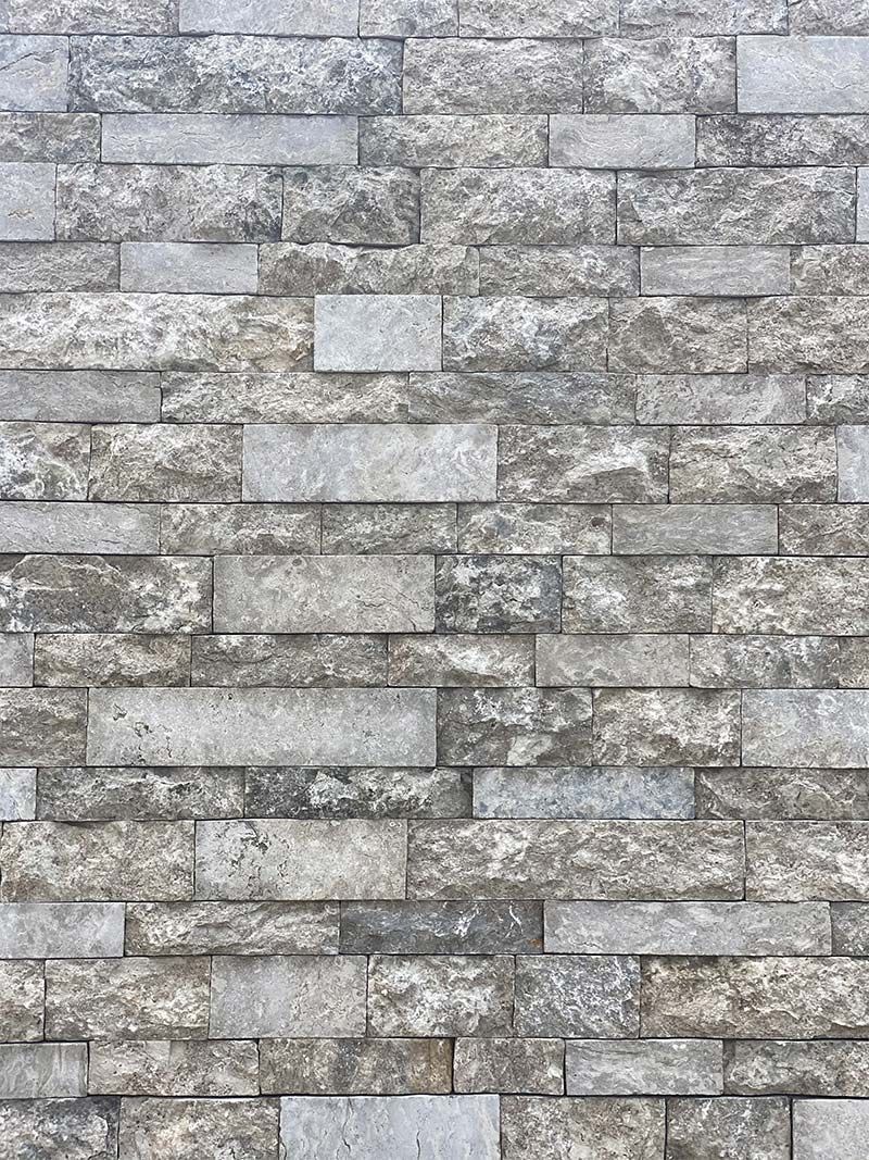 A close up of a brick wall with a lot of bricks on it.
