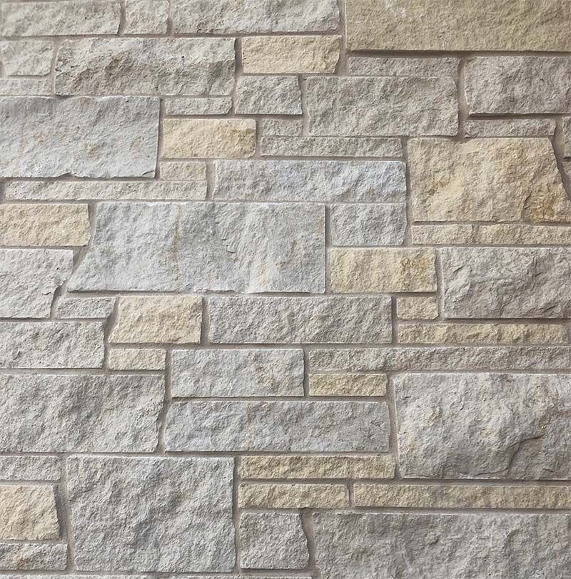A close up of a brick wall with a lot of bricks on it.