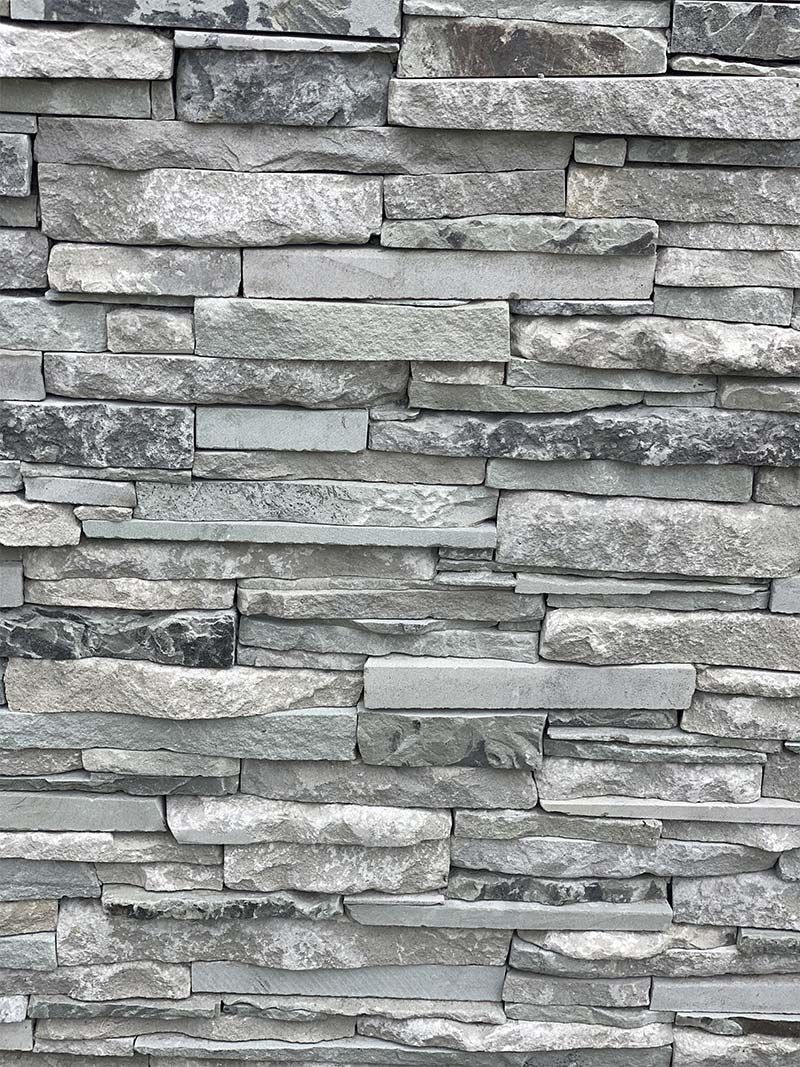 A close up of a stone wall with a lot of bricks.