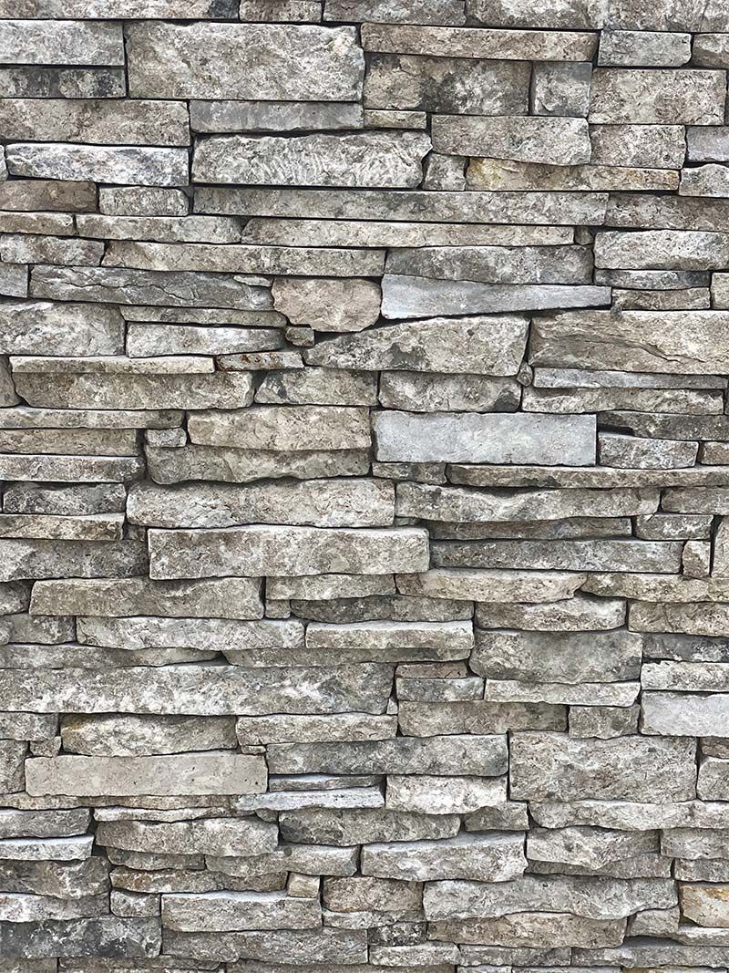 A close up of a stone wall with a lot of bricks.