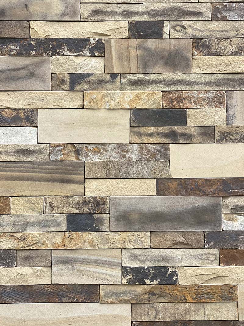 A close up of a brick wall made of different types of bricks.