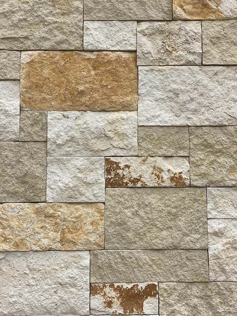 A close up of a brick wall with a lot of bricks on it.