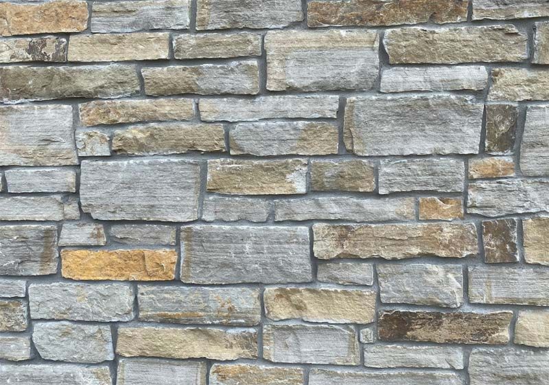 A close up of a stone wall with a lot of bricks