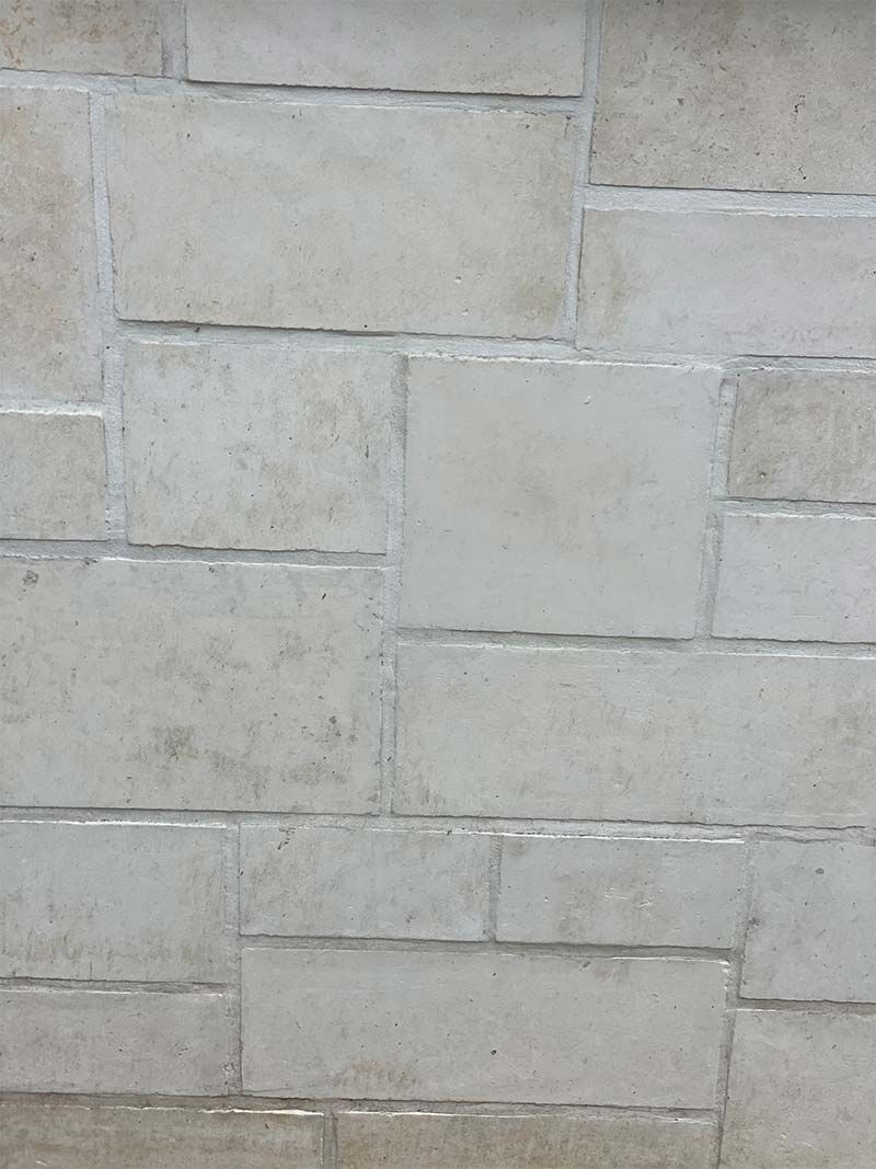 A close up of a white brick wall.