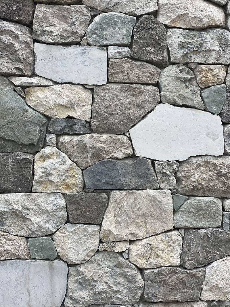 A close up of a stone wall with a hole in the middle.