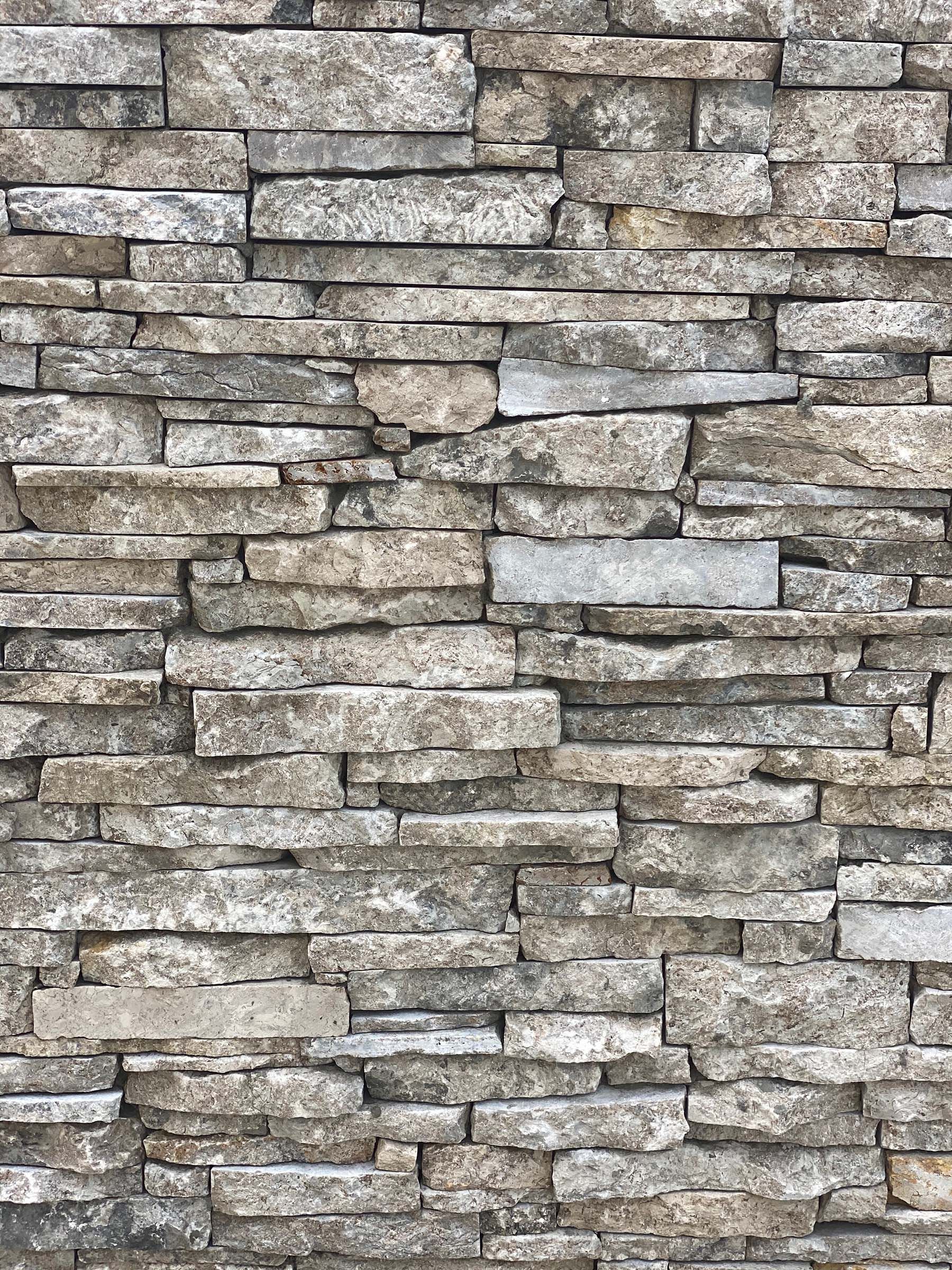 A close up of a stone wall with a lot of bricks.