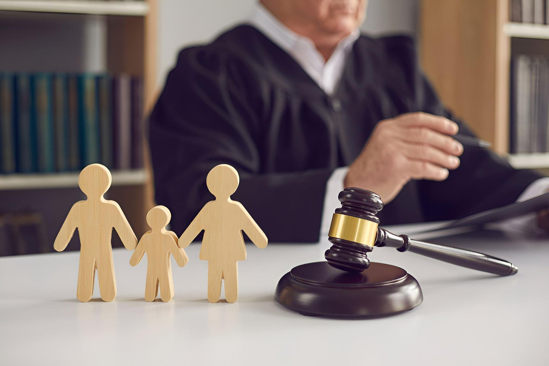 Family figures beside a judge’s gavel in a courtroom scene - Warland Solicitors & Conveyancing